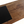 Coffee table top detail with slate insert and weathered oak planks, showing screw heads.