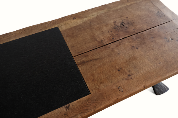 Coffee table top detail with slate insert and weathered oak planks, showing screw heads.