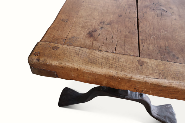 Oak coffee table tabletop close-up showing distressed grain and dark slate inset.
