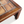 Wood bench corner with patterned ceramic tile inset on tabletop