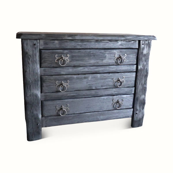 Angled view of four-drawer ebonized oak chest with ornate metal knobs, blue-gray finish