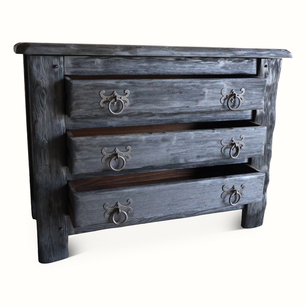 Front close-up of four-drawer ebonized oak chest with ornate metal pulls, dark finish