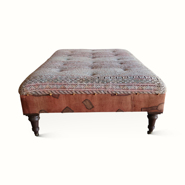 Tufted ottoman seat with geometric textile panel and dark carved wood legs