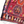 Turkish kilim rug with burgundy weave, hexagon medallions, multicolor accents and fringed hem.
