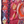 Turkish kilim rug close-up, burgundy fabric with navy diamonds, orange stripes and small motifs.