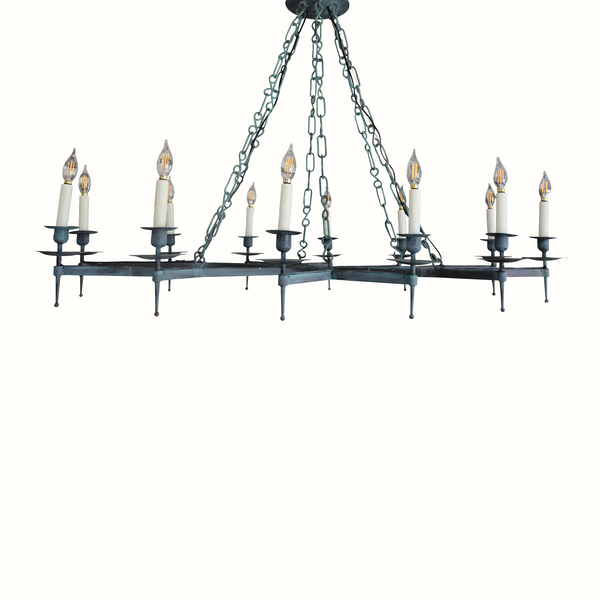 Verdigris iron chandelier with dark arms and eight candelabra bulbs on chains