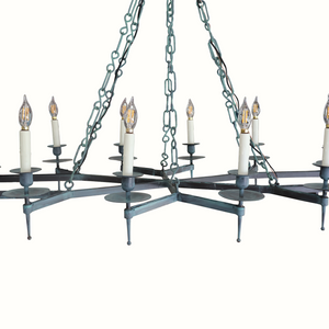 Iron chandelier with multiple candelabra bulbs, dark teal arms, and hanging chains
