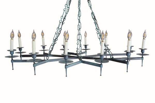 Iron chandelier with multiple candelabra bulbs, dark teal arms, and hanging chains