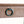 Drawer front of a cerused oak console with teal ring pull and wood grain texture