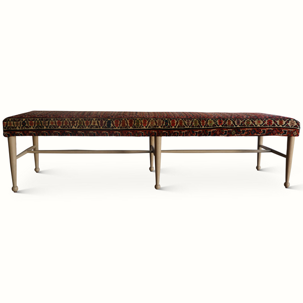 Patterned bench with multicolor geometric rug seat and border, light wood frame