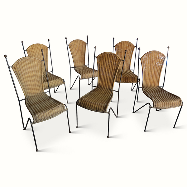 Set of six wicker chairs with dark iron frames, arched backs and woven seats