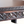 Antique Moroccan table edge close-up with carved triangle and diamond pattern