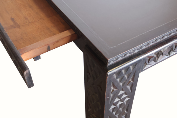 Antique Moroccan table corner detail with carved leg panels and distressed finish