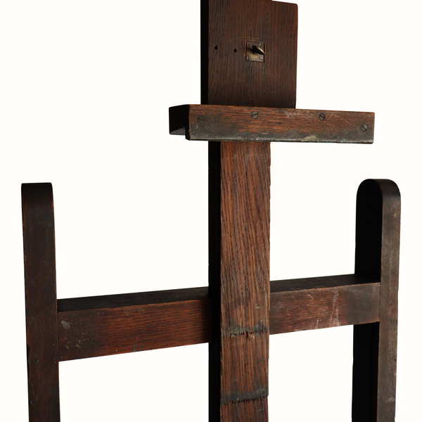 Antique wooden easel with metal hardware on the crossbar and side rails