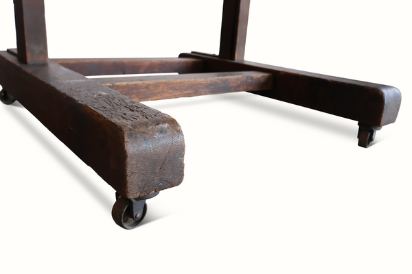 Antique wooden easel base with thick arms and corner casters