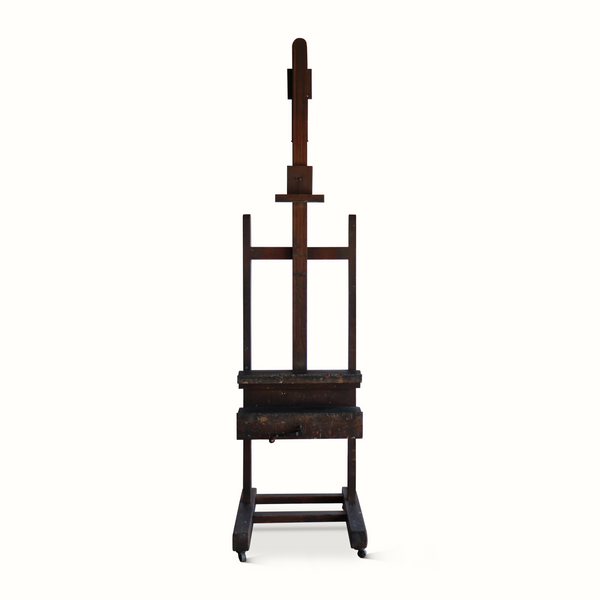 Antique wooden easel with tall back support, lower shelf, and four rolling feet