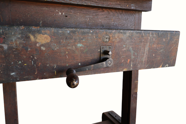 Antique wooden easel with crank handle and drawer pull on worn painted panel