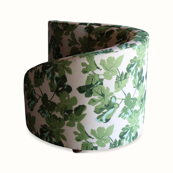 Loveseat sofa with fig-leaf print upholstery, rounded end with visible arm and leg