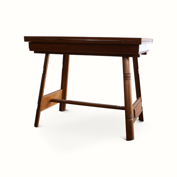Oak flip-top game table with dark brown finish, rectangular top, and tapered legs.