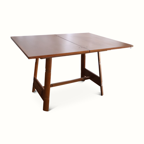 Oak flip-top game table angled view with smooth tabletop and supportive base frame.