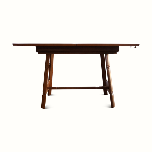 Oak flip-top game table with trestle base and underside support frame