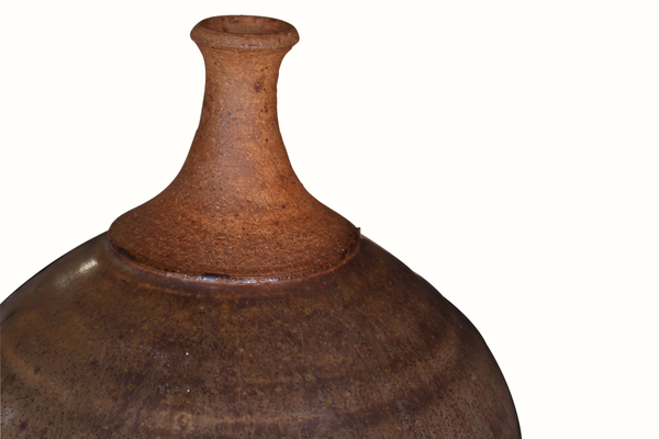 Studio pottery vase, close-up of flared neck and shoulder with speckled rust glaze.