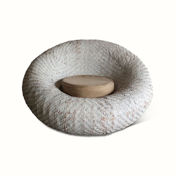 French rattan lounge chair with woven basket weave and beige seat cushion
