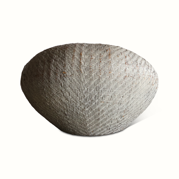French rattan lounge chair, textured woven seat in oval base with no cushion visible