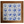 Wooden tabletop with blue-and-white Delft tile panel and circular coastal scenes