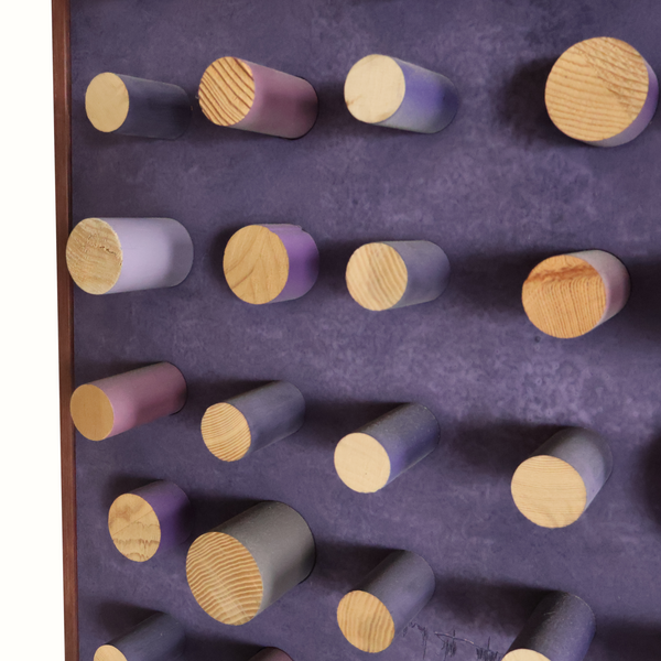 Purple peg art board with mixed-size wooden pegs in curved rows