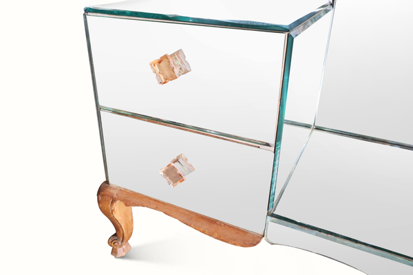 Mirrored vanity table side view with glass shelves and curved turned wood legs