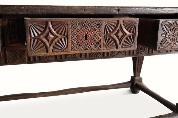 Carved oak table apron close-up with star and diamond relief patterns