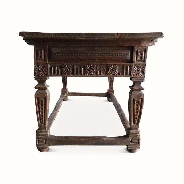 Carved oak library table front view with decorative apron and baluster legs