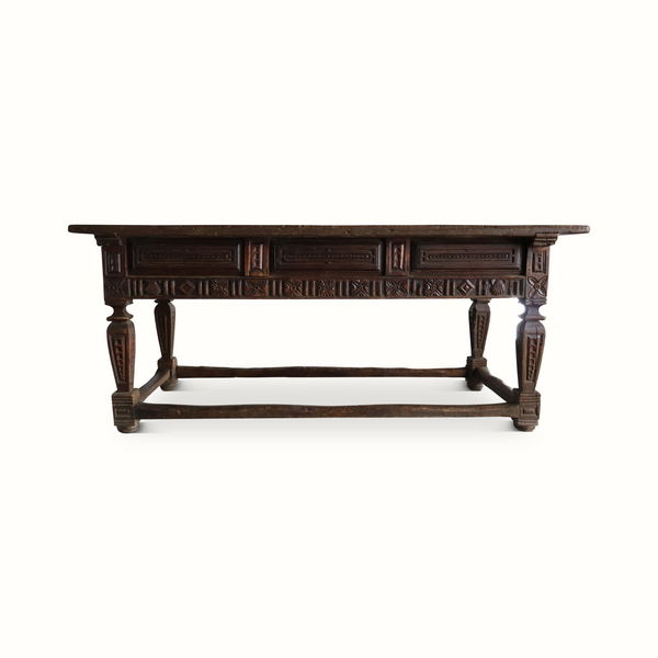 Carved oak table rear view with carved panel apron and turned legs