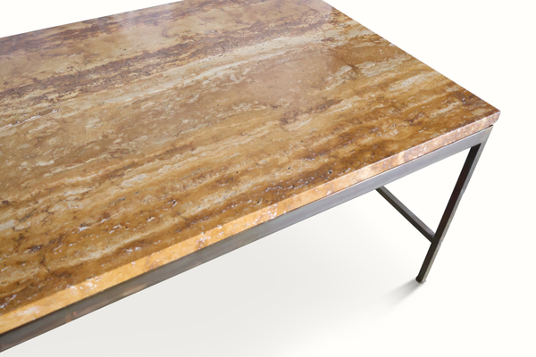 Brown stone coffee table top with speckled veining and dark metal edge