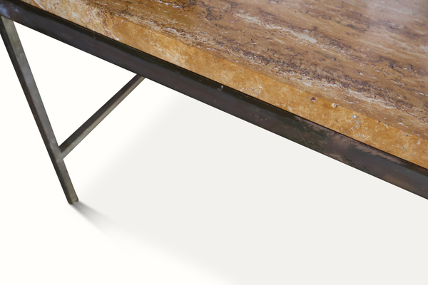 Stone coffee table edge with dark metal support bars beneath