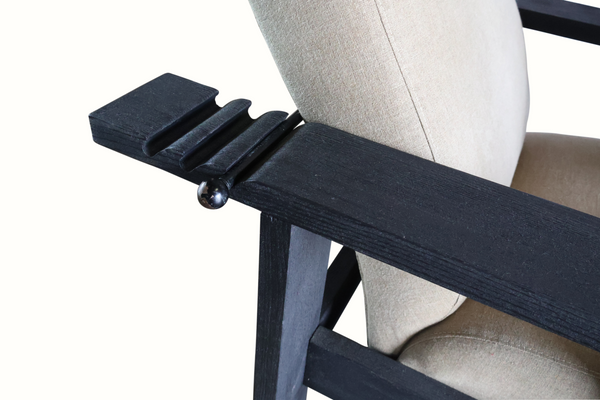 Reclining armchair hardware: dark lever and wood arm beside beige cushion