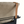 Reclining armchair close-up: beige fabric, tan leather trim, dark arm frame