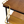 Wood shelf corner with black trim and brass frame, plus perforated basket below
