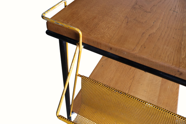 Wood shelf corner with black trim and brass frame, plus perforated basket below