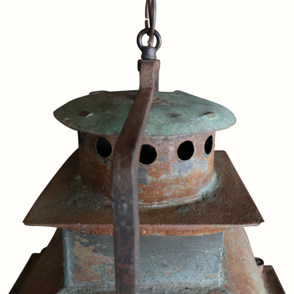 Hanging metal lantern with wide green top, perforated chimney, and rusted hanging chain