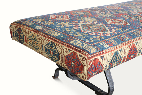 Kilim carpet bench seat detail with blue, red, and cream geometric woven pattern