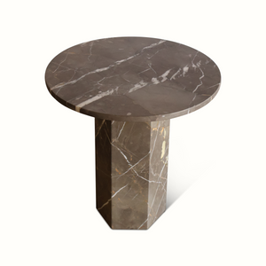 Round dark marble side table with white veining and tapered stone base