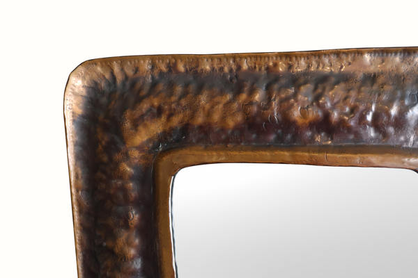 Vintage copper mirror frame close-up, textured top border and rounded corners