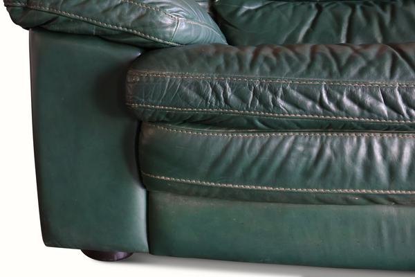 Dark green leather sofa arm and seat cushion with contrast stitching