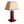 Red leather table lamp with tall column and square base, beige shade, brass top.