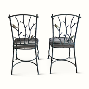 Pair of dark metal side chairs with branch-style backs and slatted seat bars
