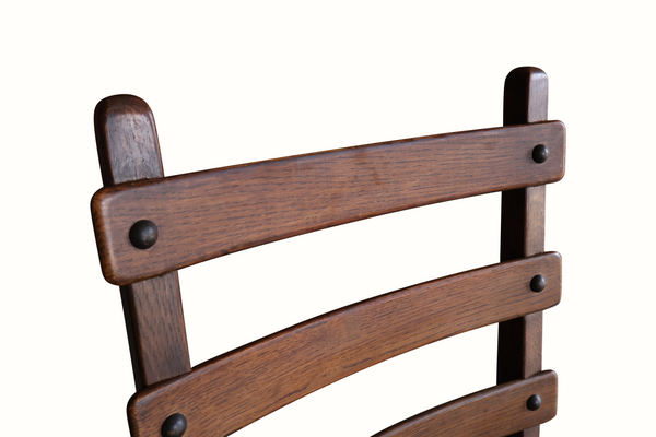 Oak ladderback chair back slats with metal pegs and dark stained wood.