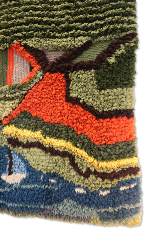 Woven landscape tapestry corner with orange road, blue water, green trees, fringed edge