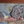 Close-up of scenic pottery tile surface, textured gray-and-pink landscape with raised accents